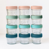 Set of glass jars with colorful lids stacked on a white background